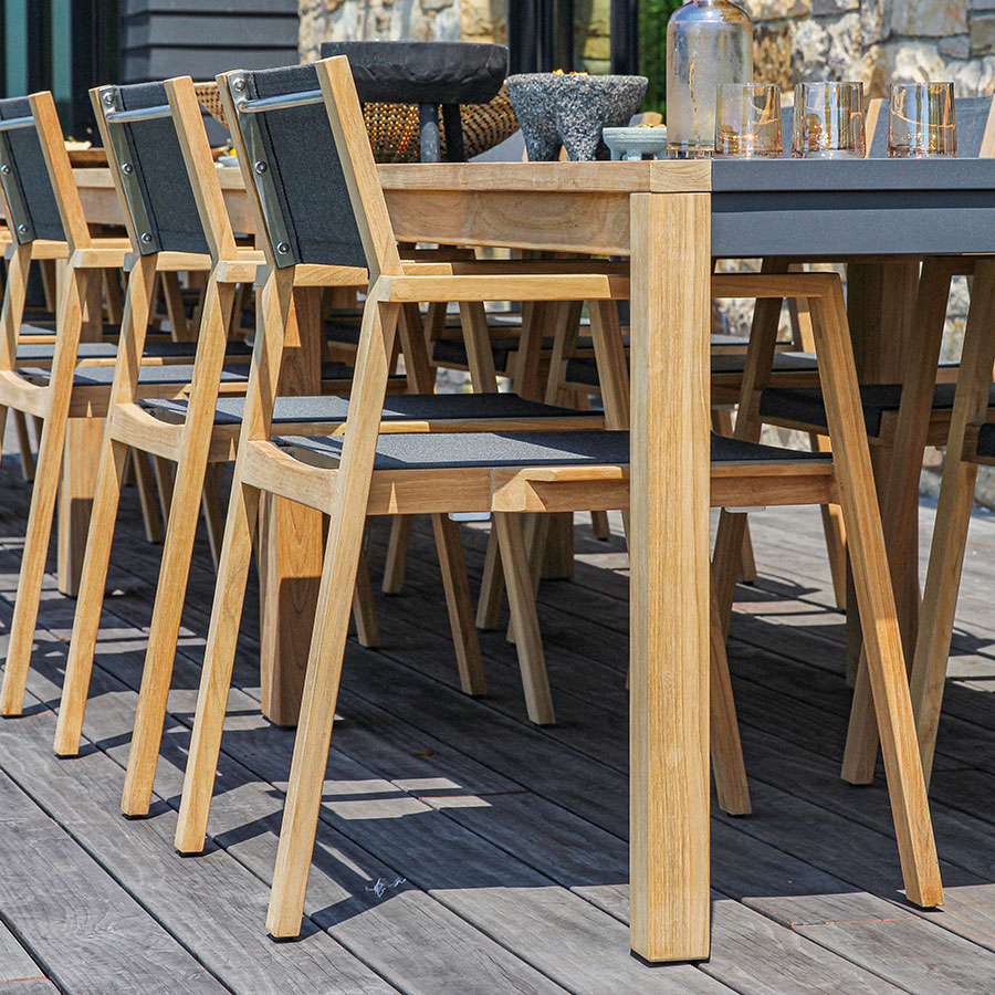 Summit solid teak and mesh sling outdoor modern stacking armchair.