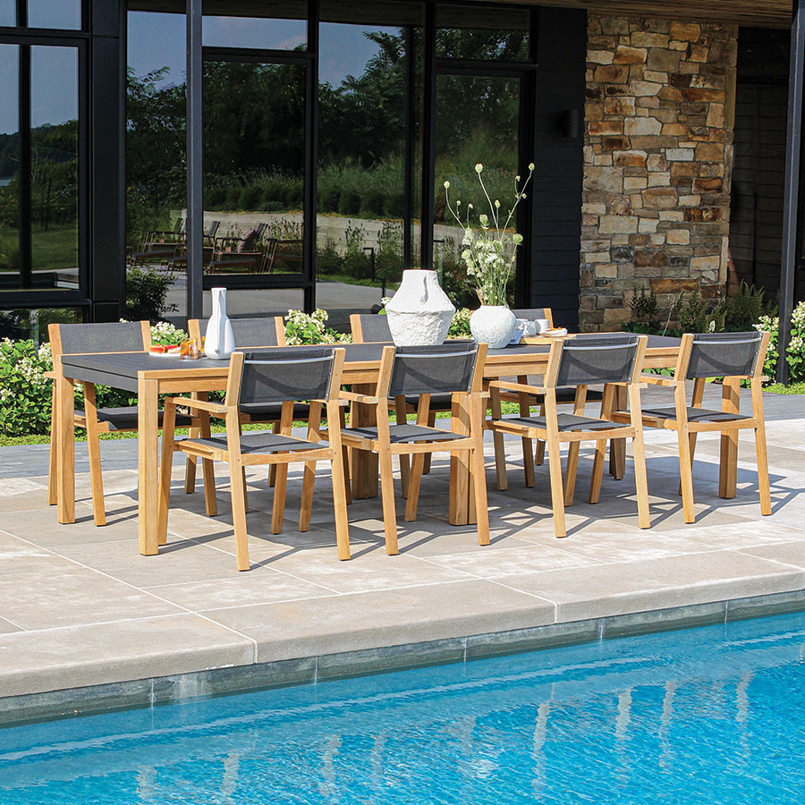 Summit solid teak wood and powder-coated aluminum 10 ft long outdoor dining table and chair set.
